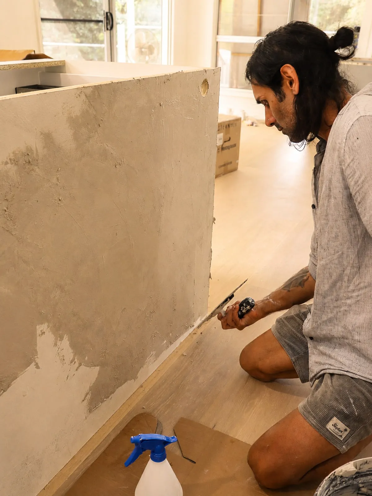 Francis at work on the microcement install, on site